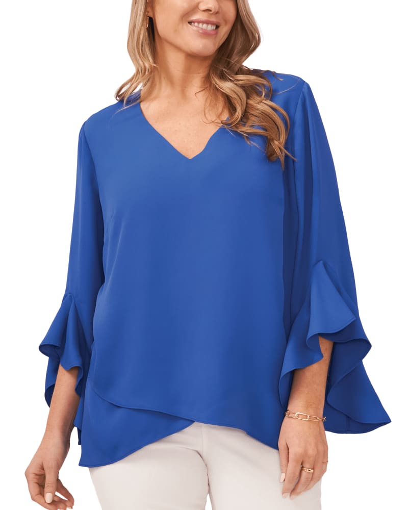Front of a model wearing a size 1X Natalie Flutter Sleeve Tunic in DEEP AZURE by Vince Camuto. | dia_product_style_image_id:261178